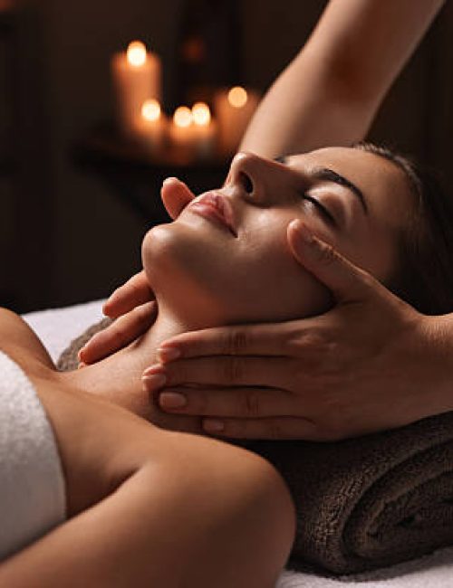 Attractive woman enjoying face massage, closeup. Beauty procedure